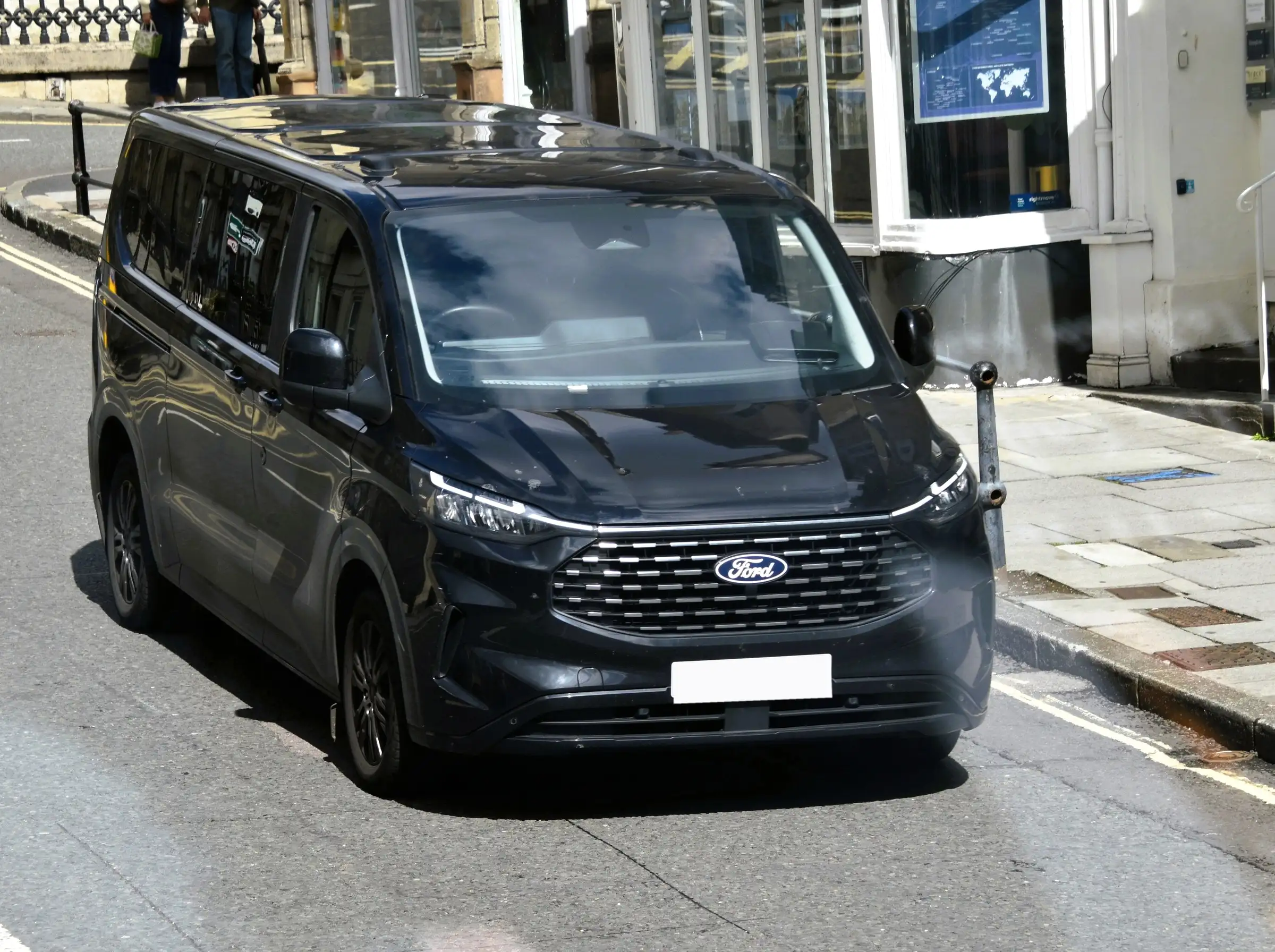 A black seven-seat Business MPV on a town street