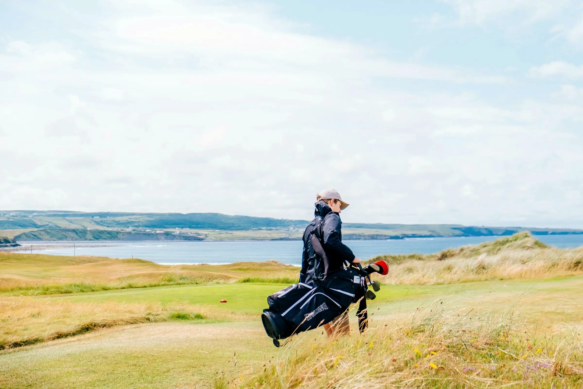 A golfer crossing the links at Lahinch Golf Club in County Clare