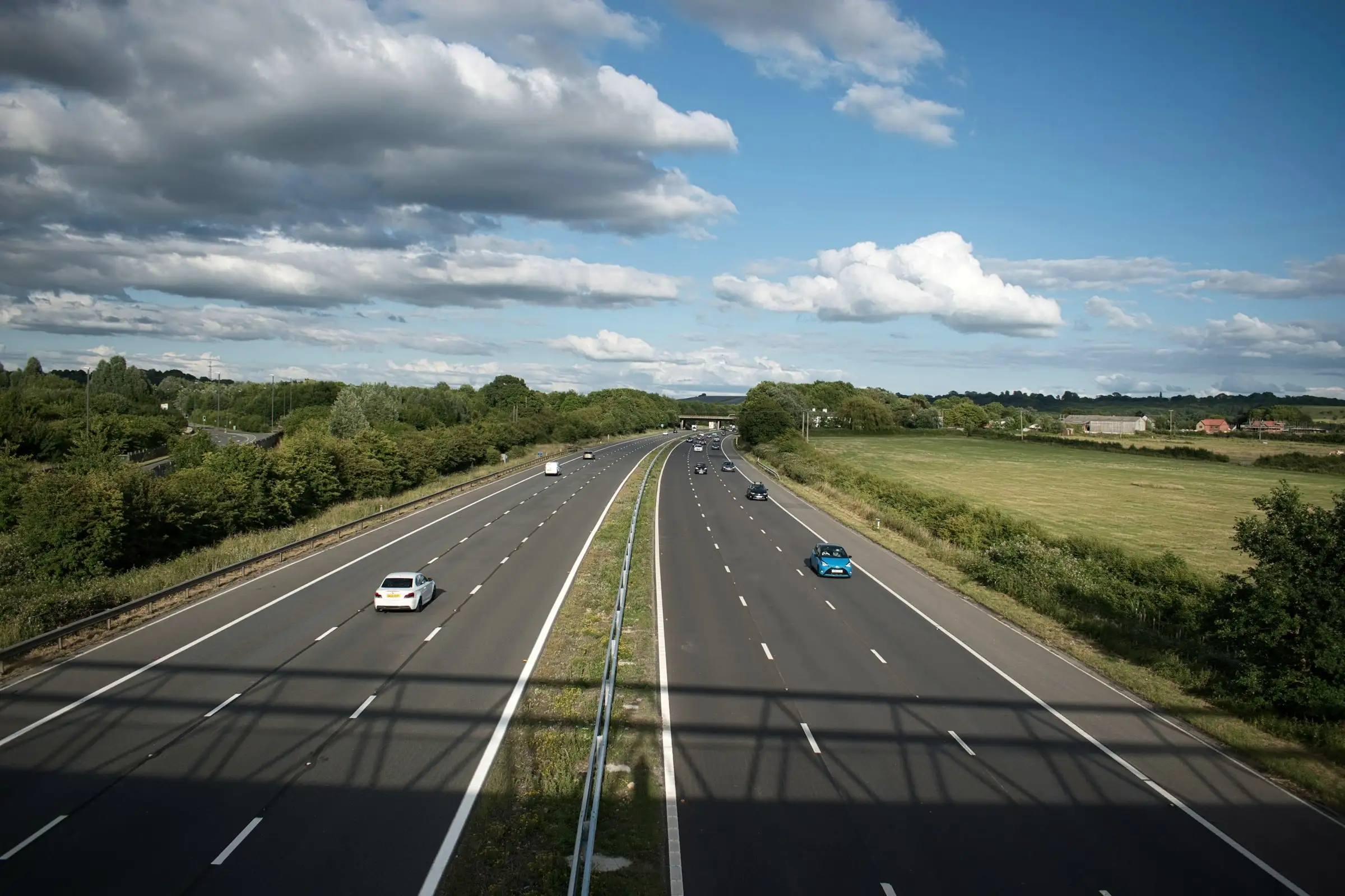 A motorway running through green countryside